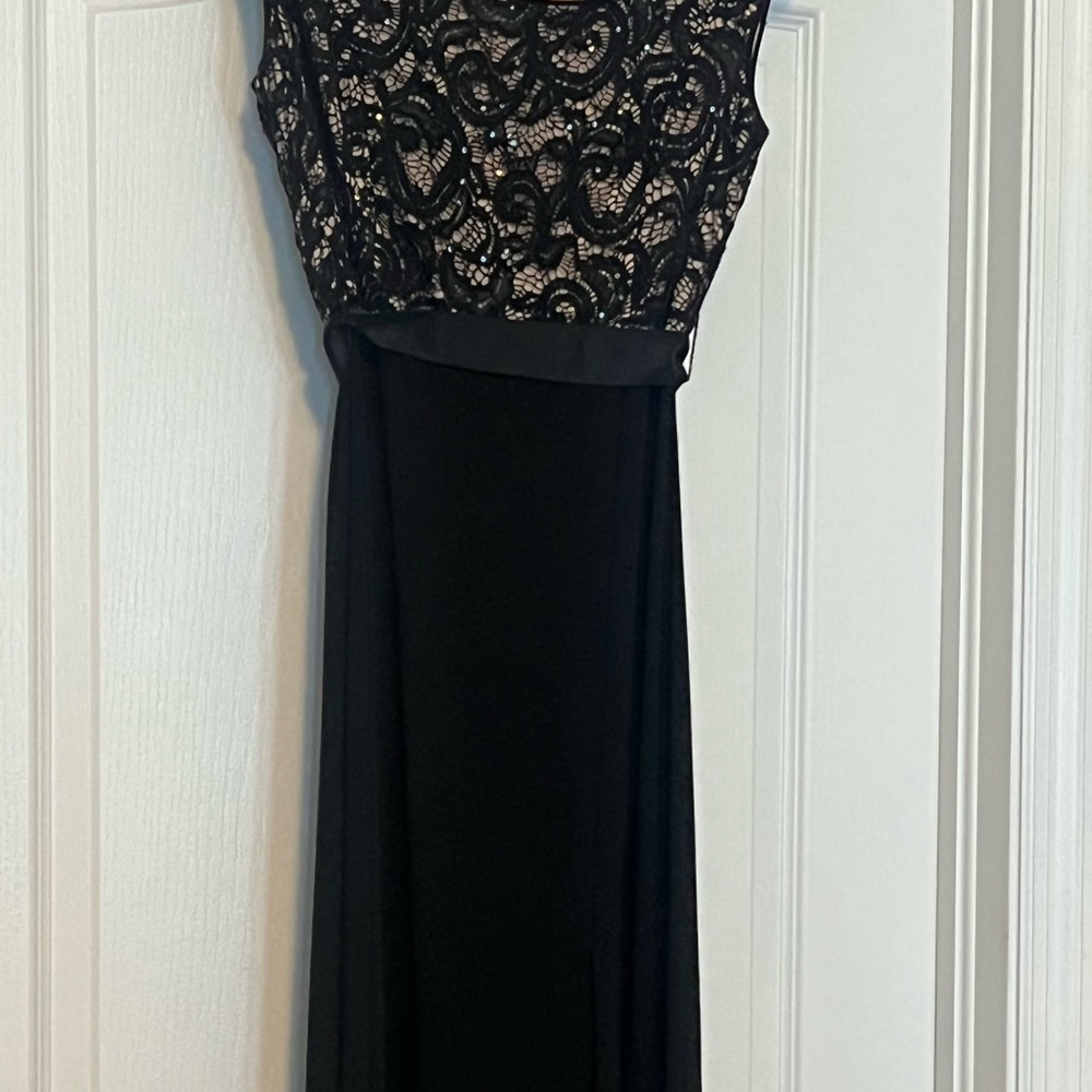 Long black dress. Lace on upper part.